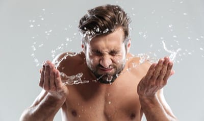 Man rinsing face