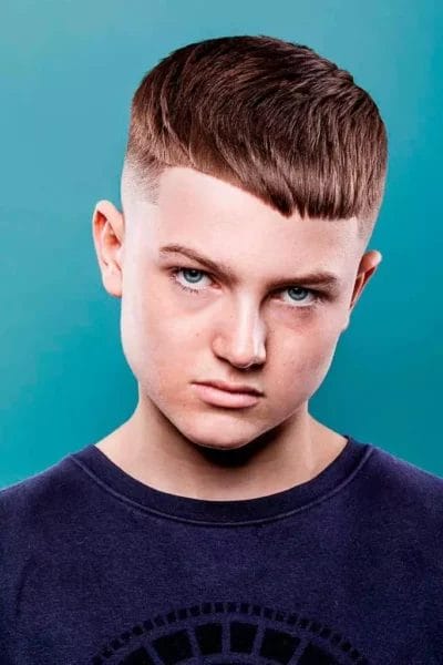 Boy's Fade Haircuts: Cool & Trendy Styles for Your Little Fashion Icon 17 The Modern Undercut Haircut For Boys With A Mid Bald Fade